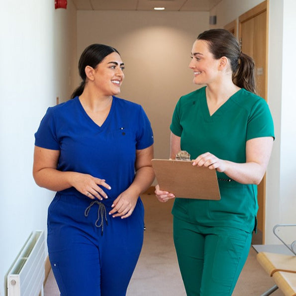 Girls wearing blue and green scrubs