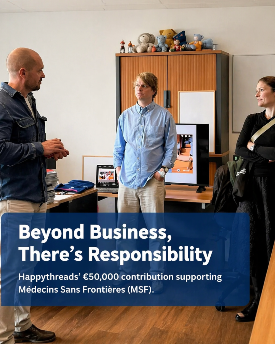 Happythreads team presenting €50,000 contribution to Médecins Sans Frontières during office meeting in a modern workspace