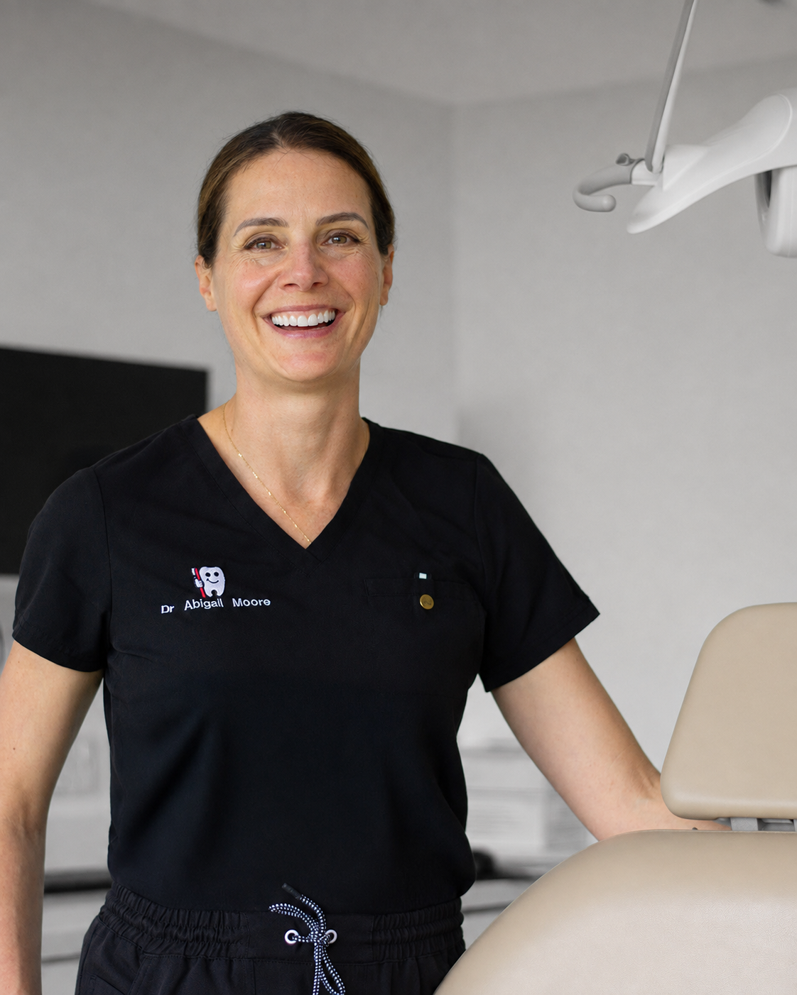 Dr Abbey smiling and posing in dental treatment room