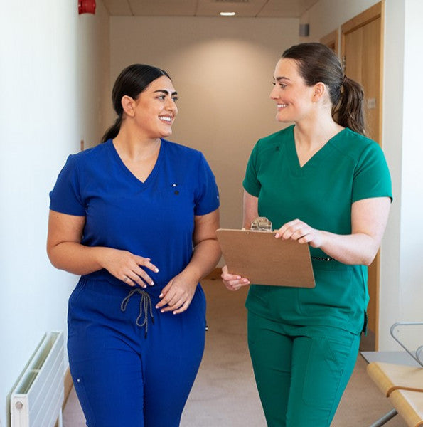 Girls wearing blue and green scrubs