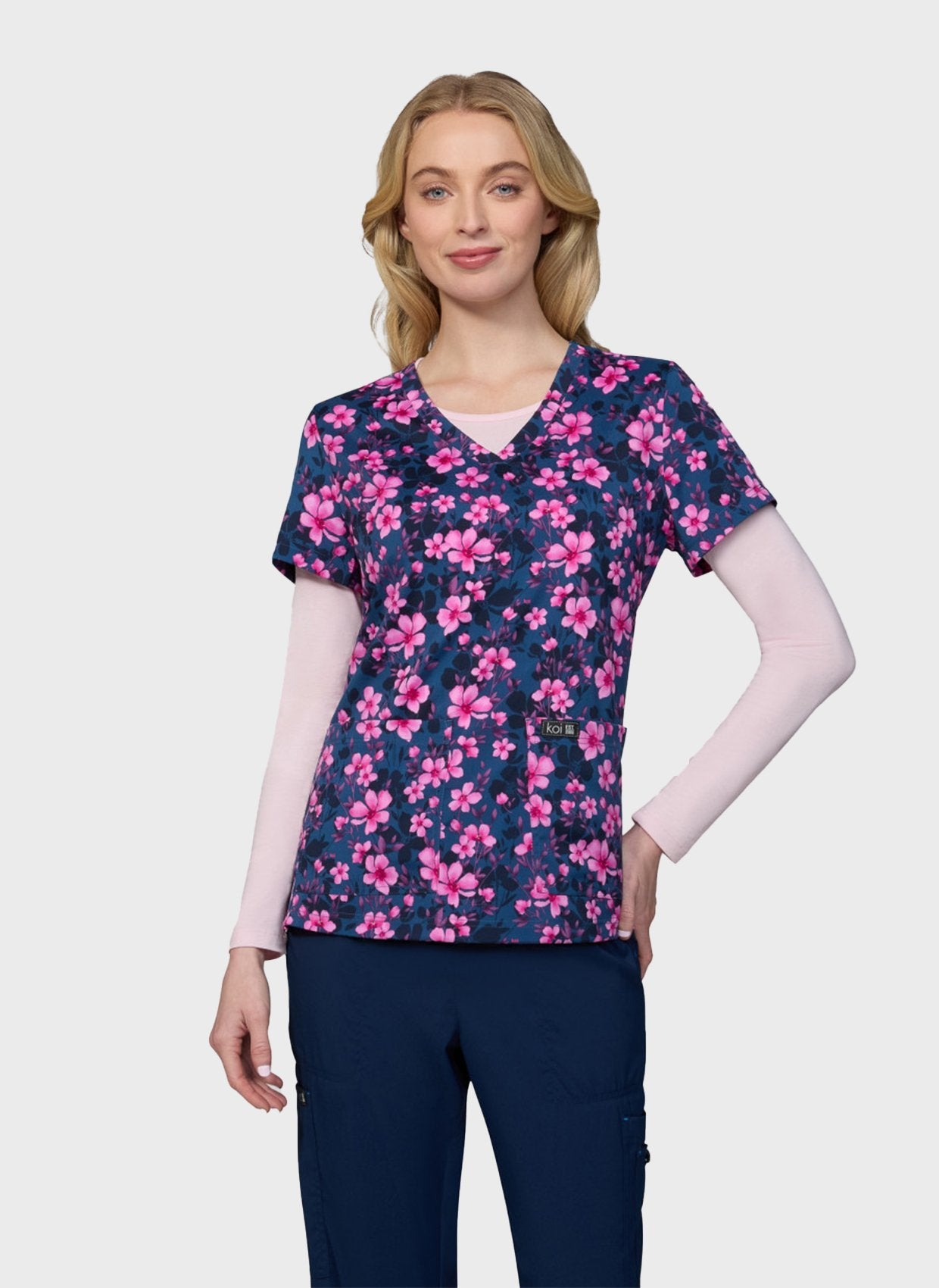 Woman wearing the Petal and Bloom printed scrub top